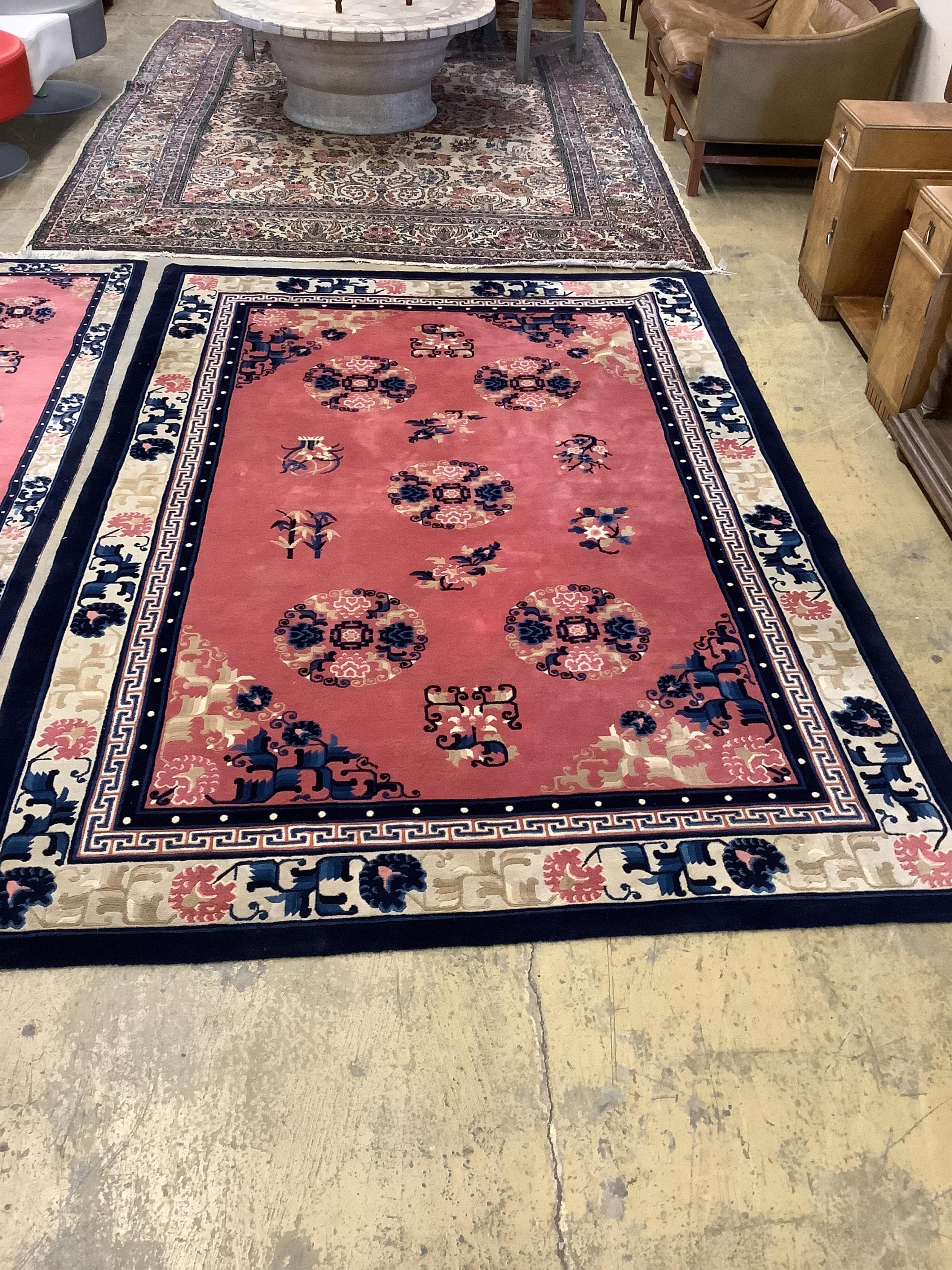 A Chinese pink ground carpet, approx. 274 x 183cm, and a similar runner, approx. 75 x 351cm (2). Condition - fair to good